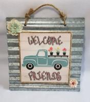 A cute truck with flowers welcome friends sign using hardboard and metal.